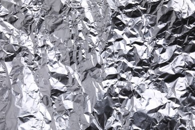 Crumpled silver foil as background, closeup view