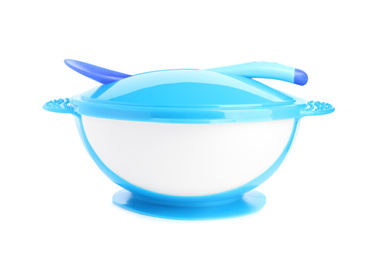 Plastic bowl with lid and spoon isolated on white. Serving baby food