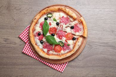 Photo of Delicious pizza Diablo and napkin on wooden background, top view