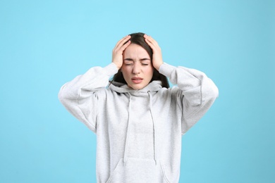 Photo of Portrait of stressed young woman on light blue background