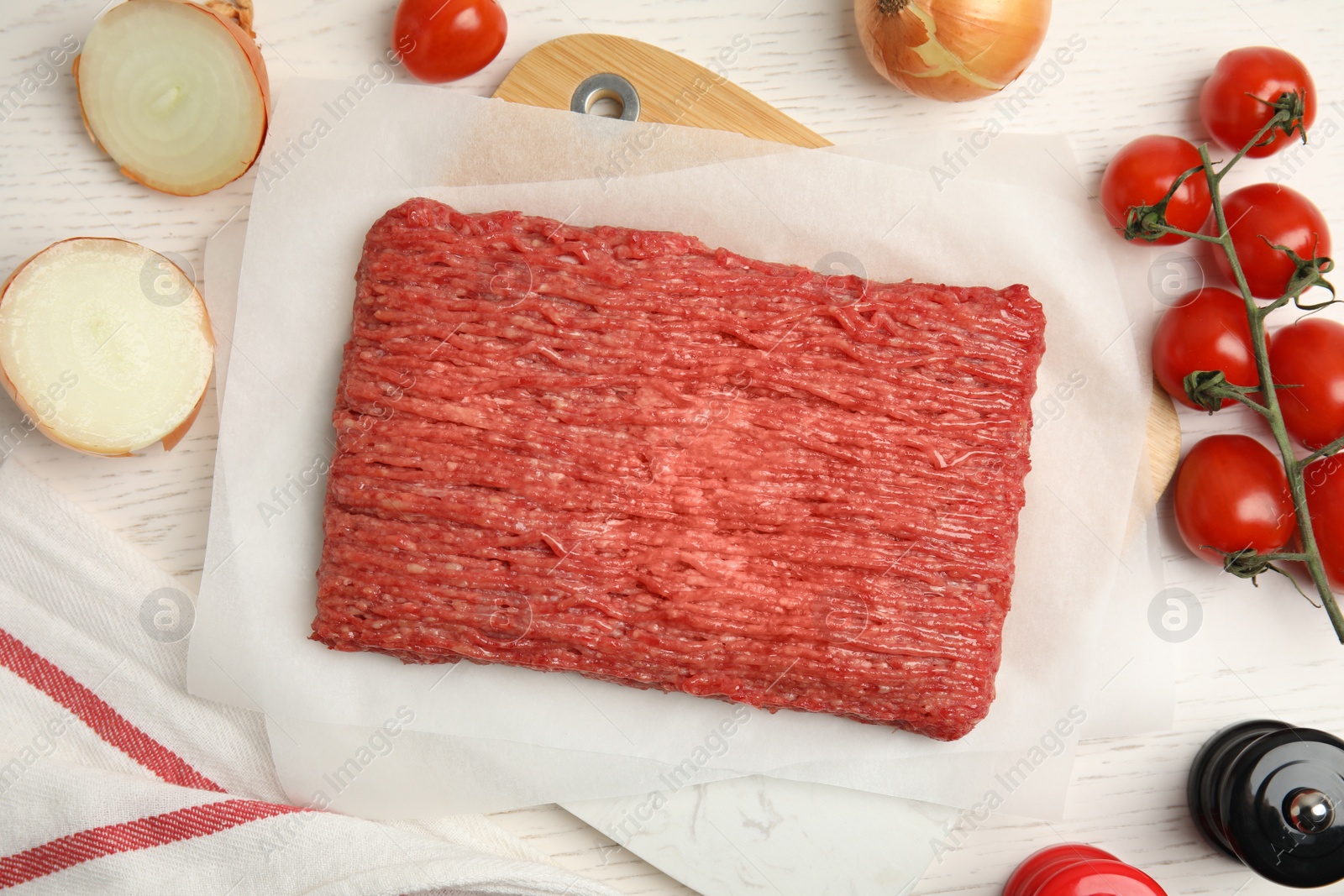 Photo of Raw fresh minced meat and other ingredients on white wooden table, flat lay