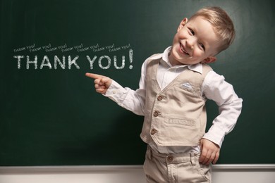 Cute little boy near chalkboard with phrase Thank You!