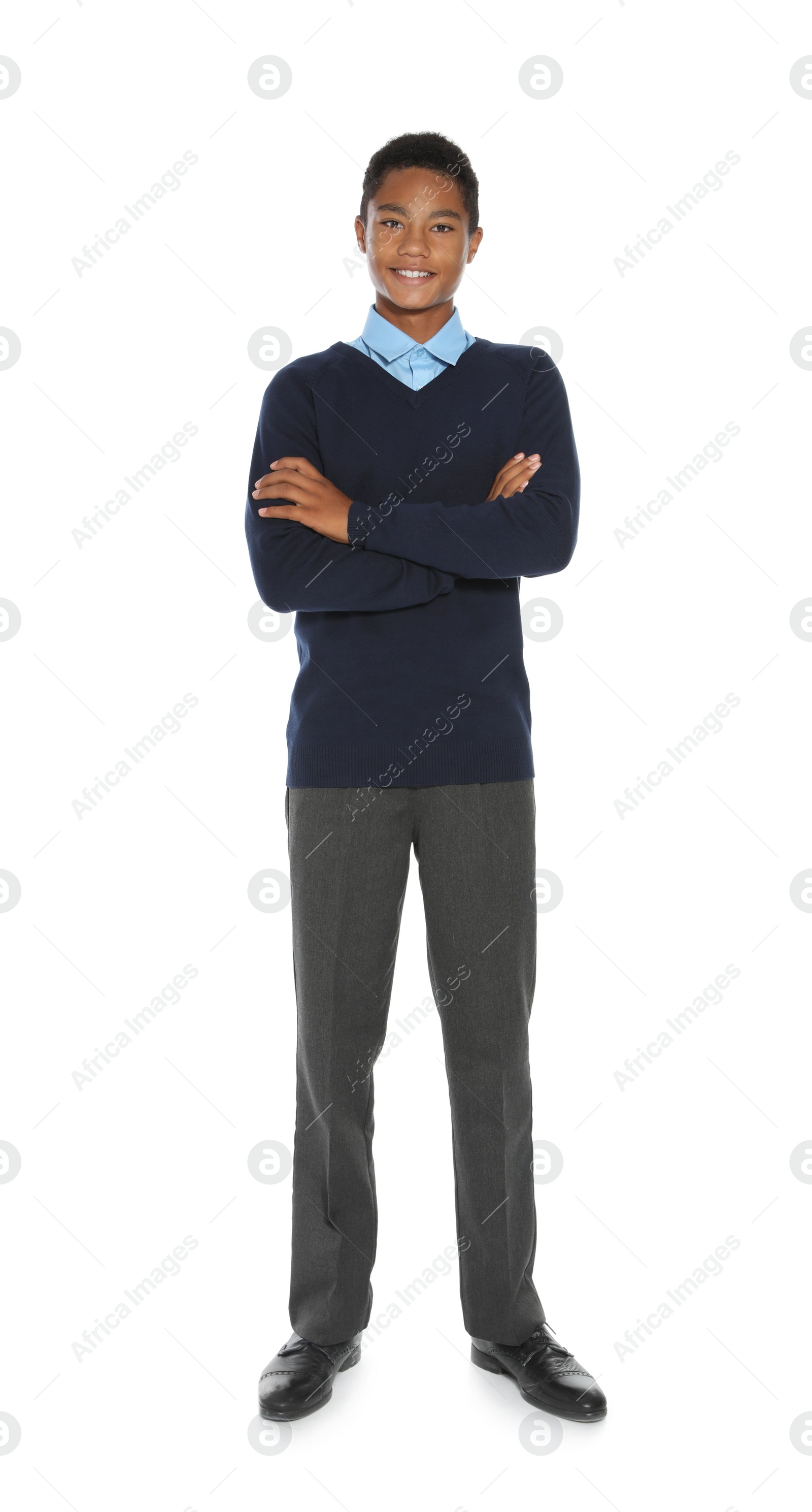 Photo of African American teenage boy in stylish school uniform on white background