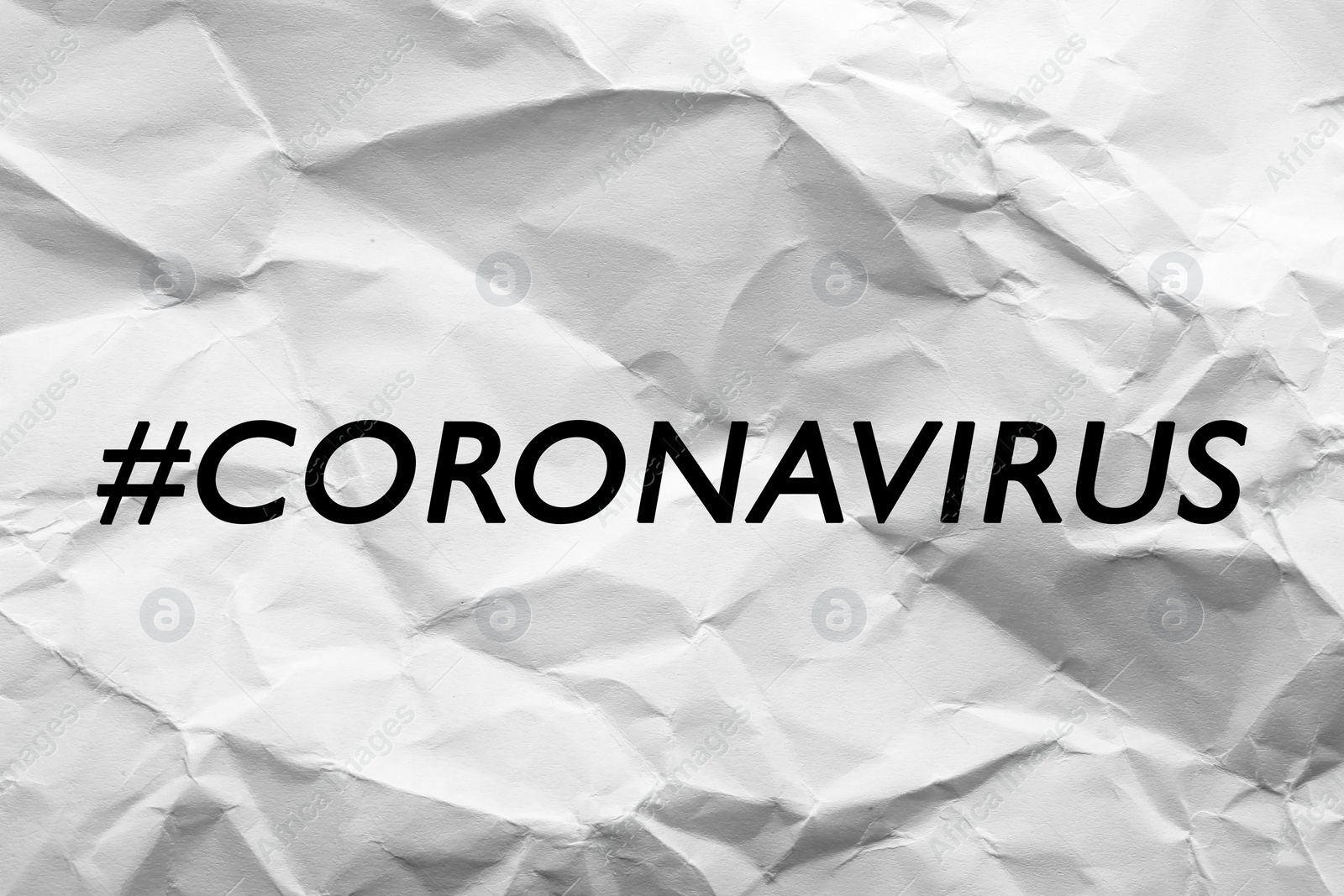 Image of Hashtag Coronavirus written on white crumpled paper
