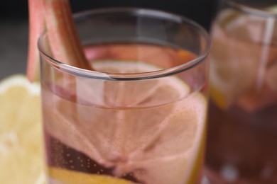 Glass of tasty rhubarb cocktail with lemon, closeup