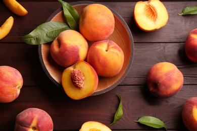 Photo of Fresh sweet peaches on wooden table, flat lay