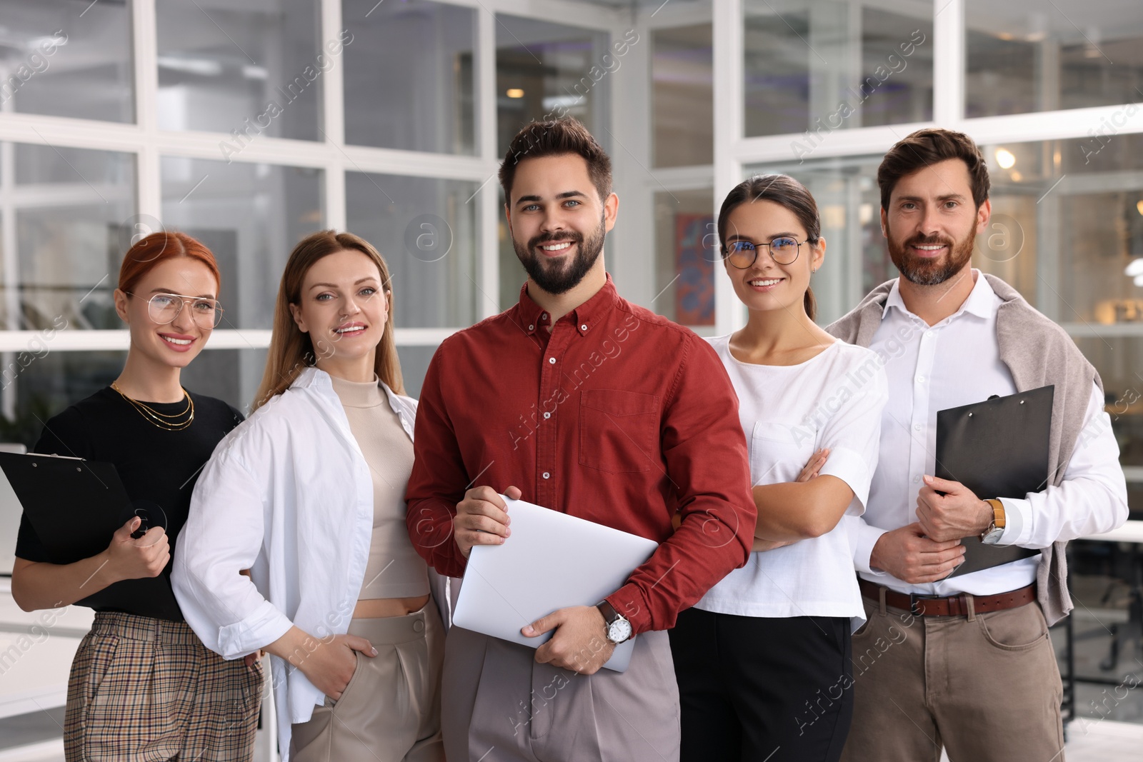 Photo of Portrait of happy employees in office. Team work