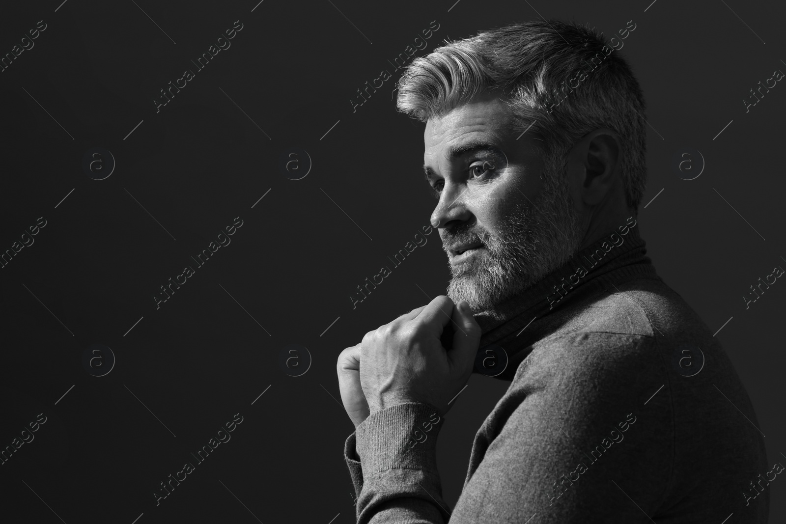 Photo of Portrait of handsome man on dark background, space for text. Black and white effect