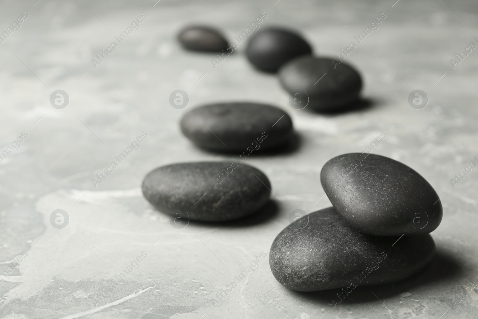 Photo of Spa stones on grey background. Space for text