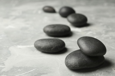 Photo of Spa stones on grey background. Space for text