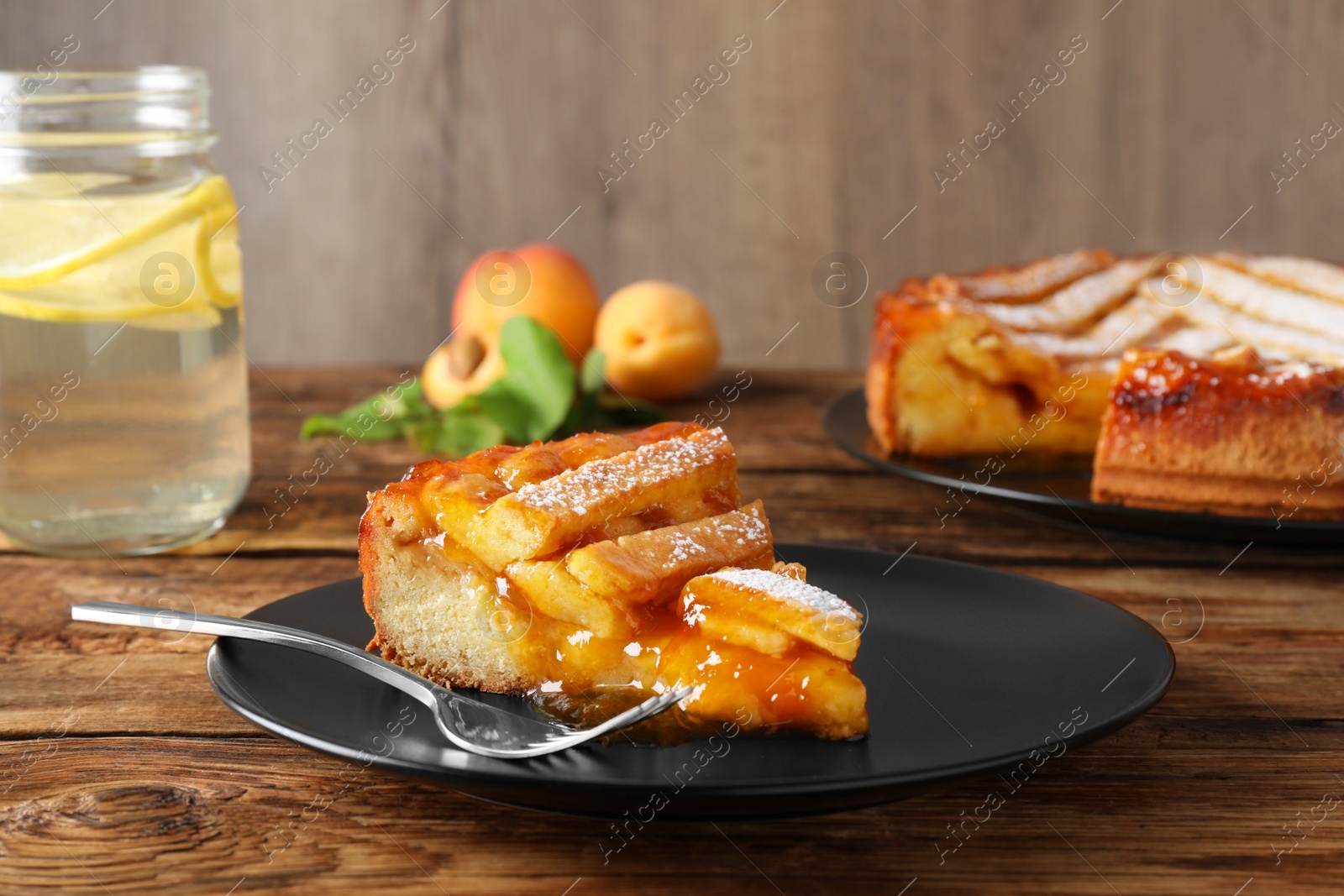 Photo of Piece of tasty apricot pie on wooden table