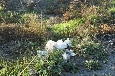 Photo of Different plastic garbage outdoors. Environmental pollution concept