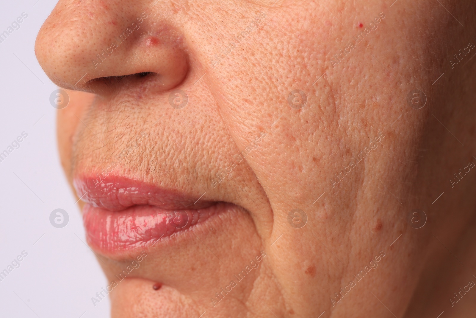 Photo of Closeup view of older woman on white background