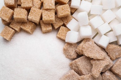 Photo of Different types of sugar as background, top view