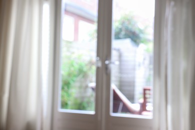 Photo of Blurred view of glass door at home