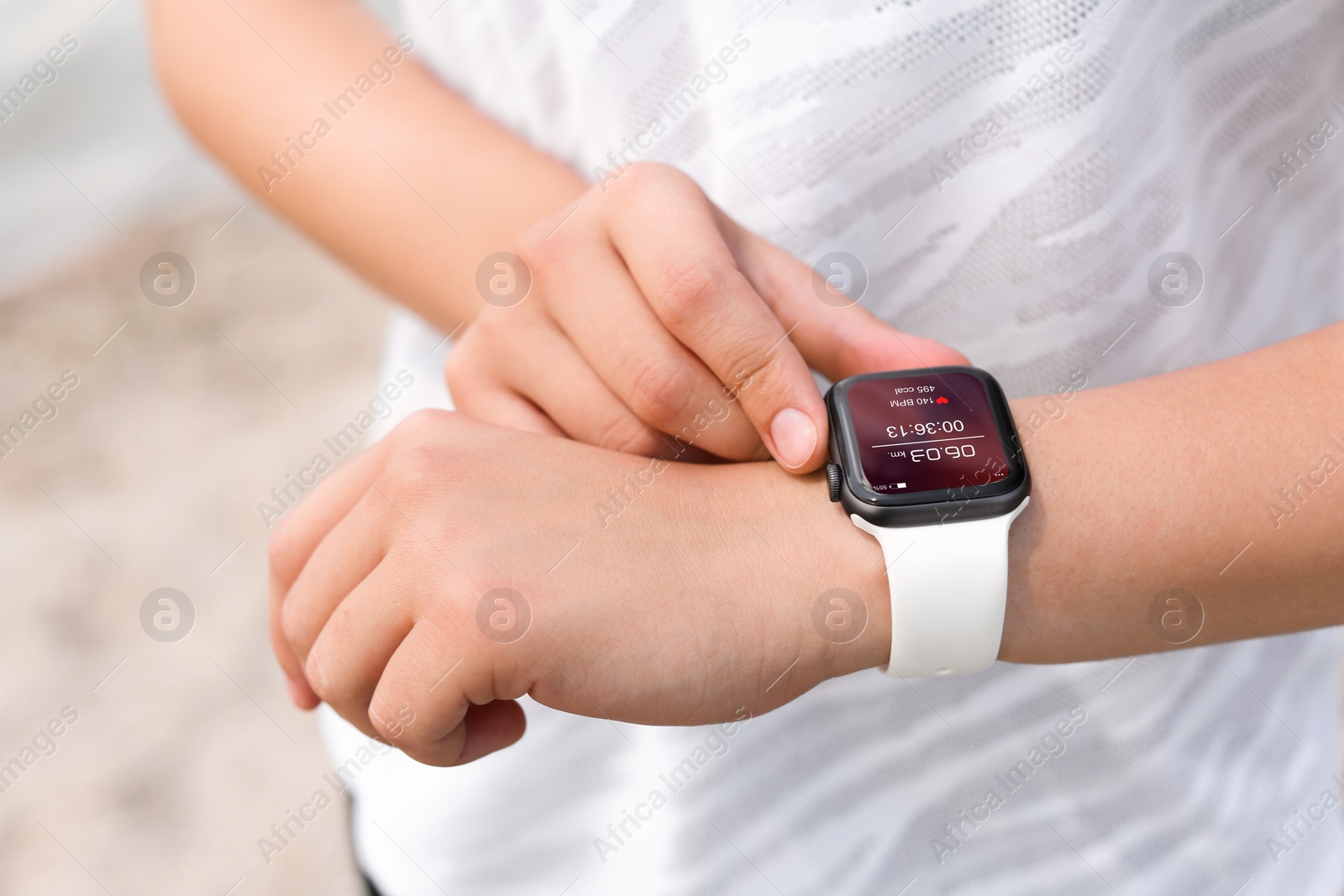 Image of Woman with smart watch checking time interval, distance, heart rate and burnt calories amount in fitness monitor app after training outdoors, closeup