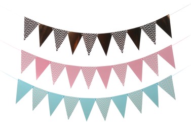 Photo of Buntings with colorful triangular paper flags on white background. Festive decor