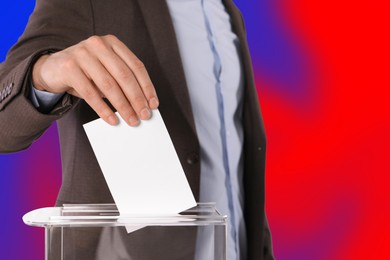 Man putting his vote into ballot box on color background, closeup