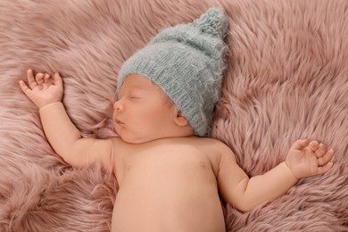 Photo of Cute newborn baby sleeping on fluffy blanket, top view