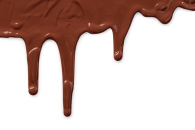 Tasty melted milk chocolate pouring down on white background