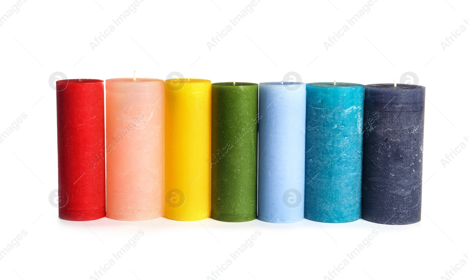 Photo of Different colorful wax candles on white background