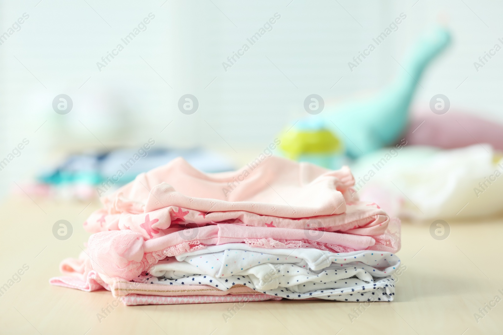 Photo of Pile of baby clothes on table