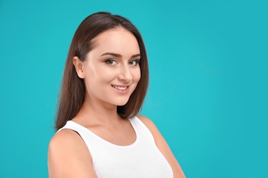Photo of Beautiful young woman in casual outfit on turquoise background