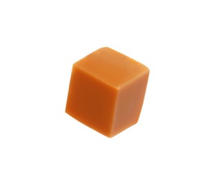 Photo of One caramel cube isolated on white. Confectionery