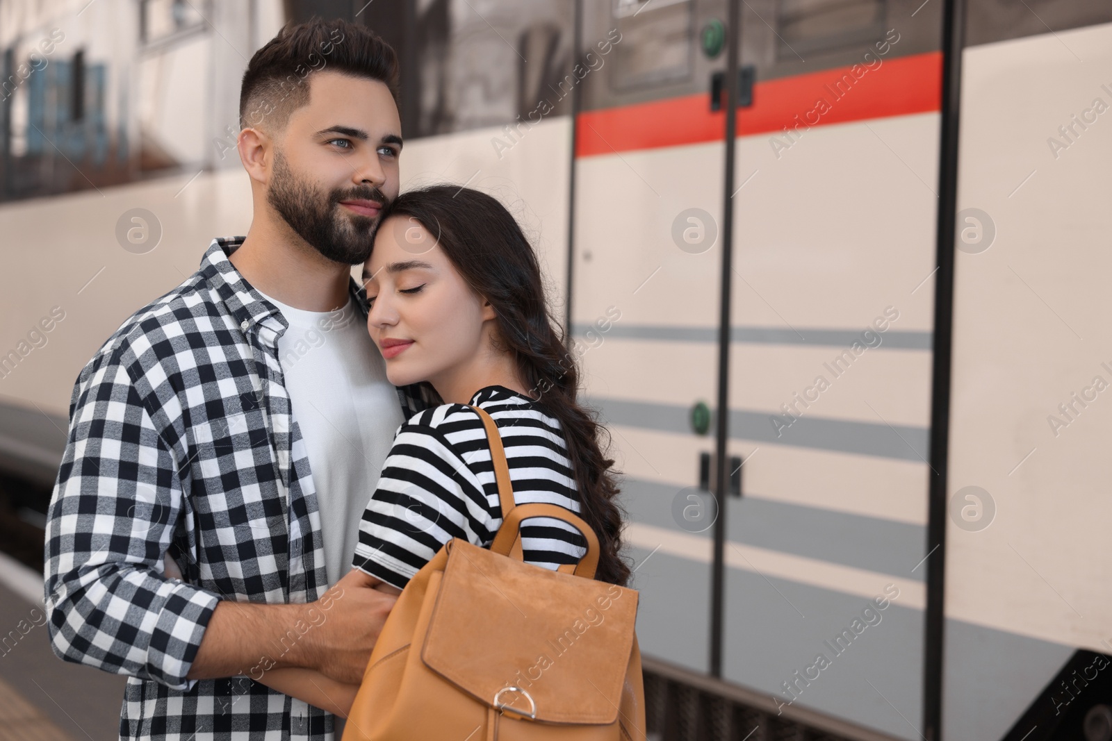 Photo of Long-distance relationship. Beautiful couple on platform of railway station