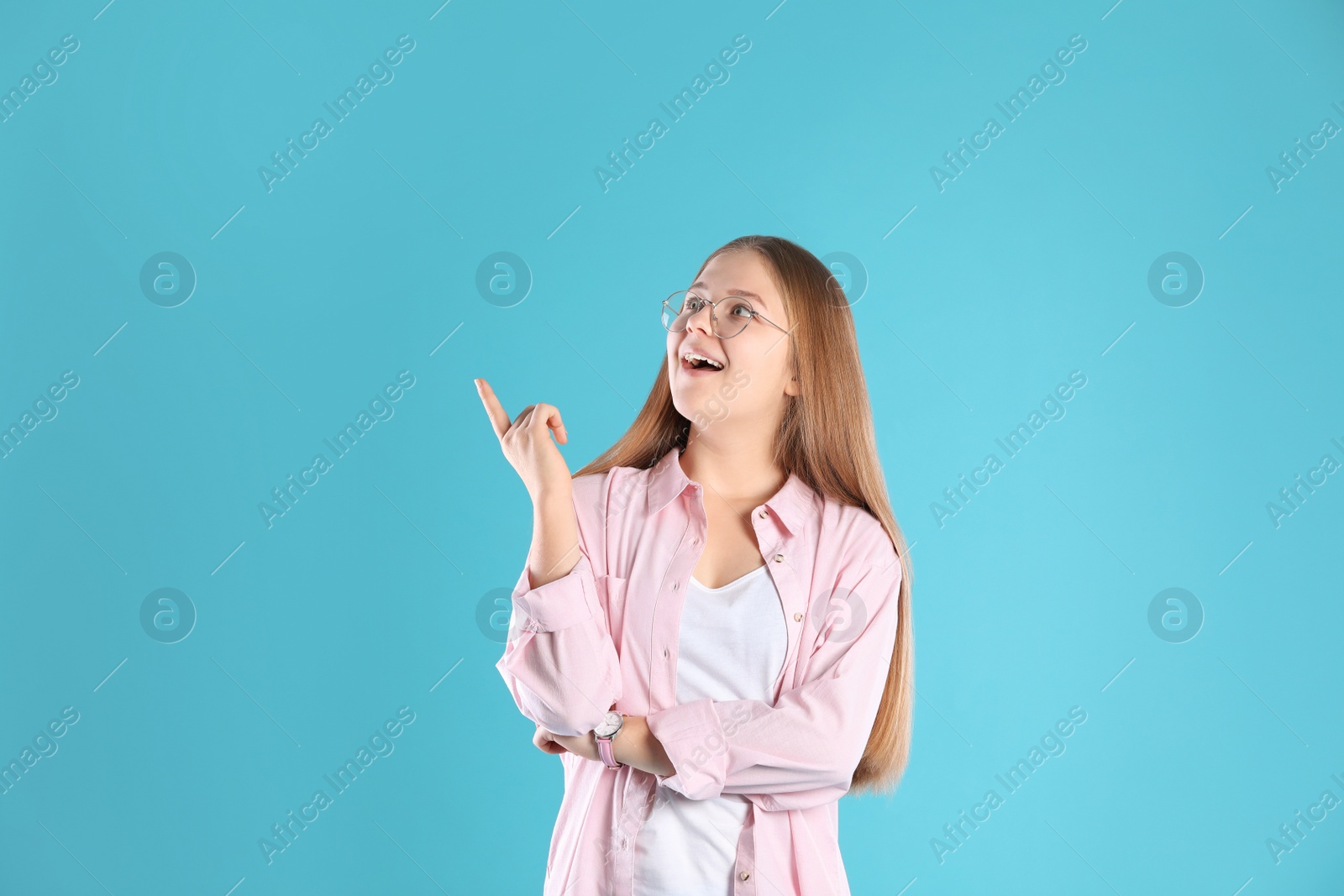 Photo of Portrait of emotional teenage girl on color background