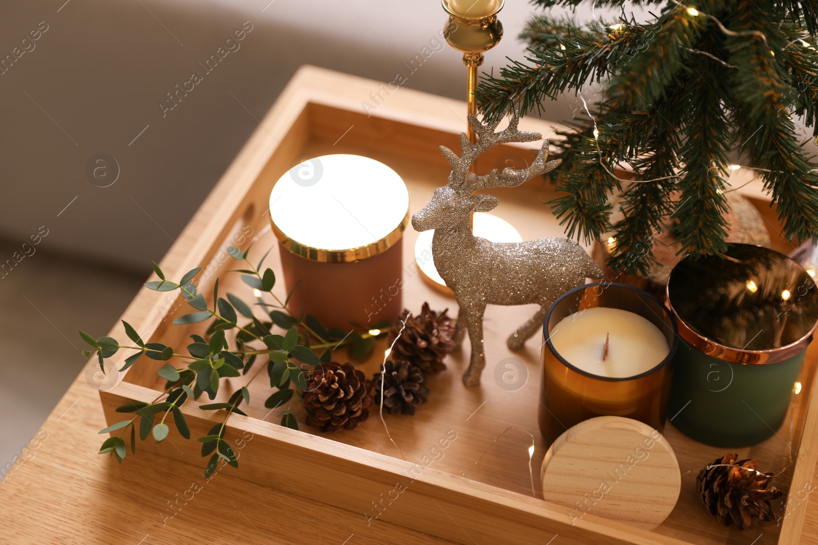 Photo of Composition with decorative Christmas tree and reindeer on wooden tray, closeup