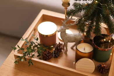 Photo of Composition with decorative Christmas tree and reindeer on wooden tray, closeup