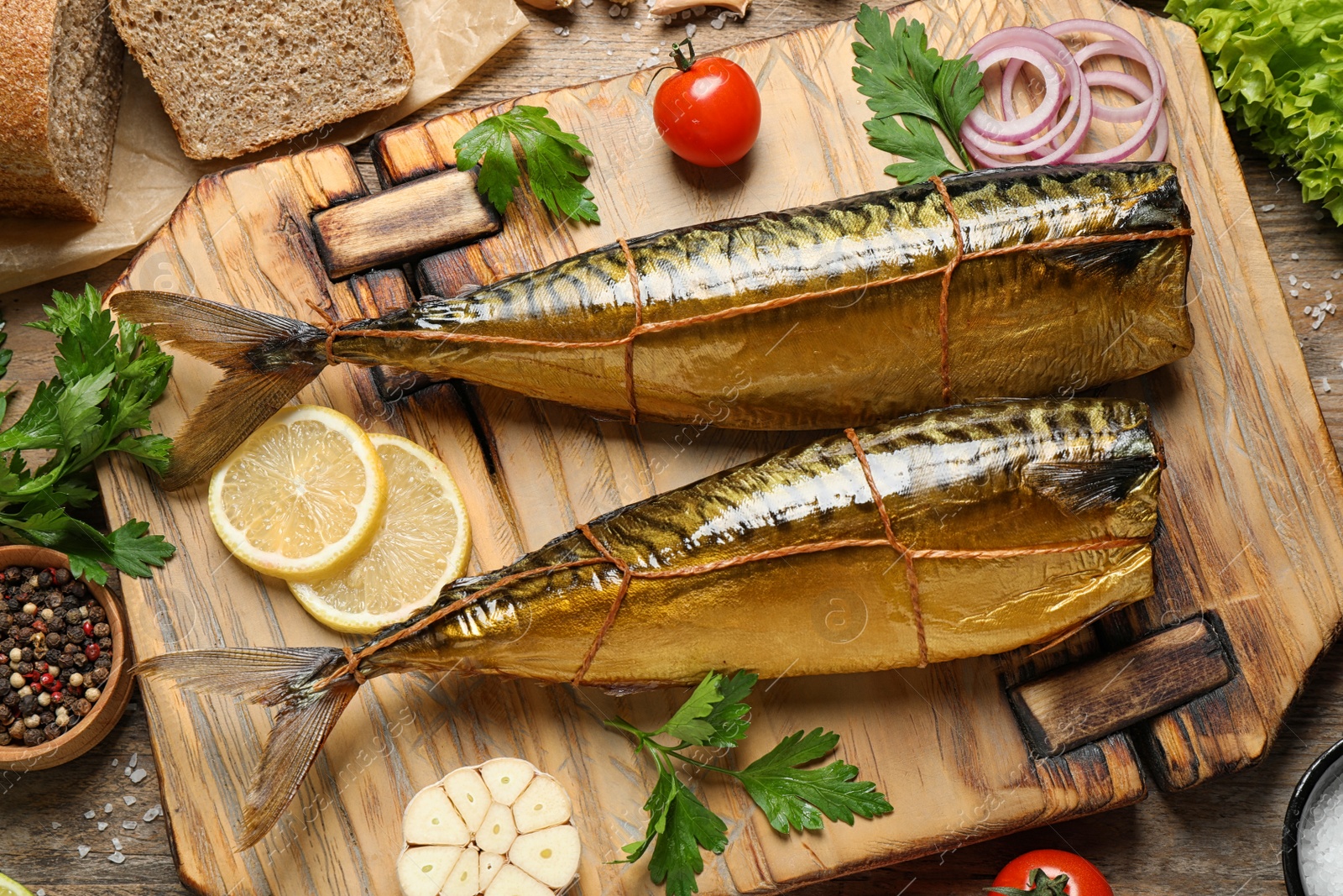 Photo of Flat lay composition with tasty smoked fish on wooden table