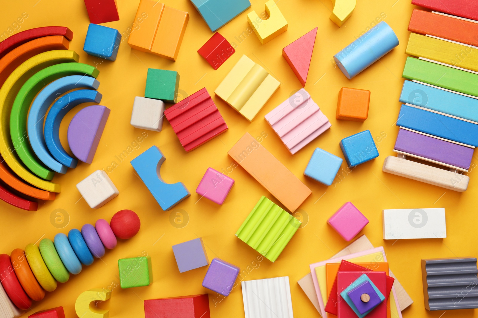 Photo of Different children's toys on yellow background, flat lay