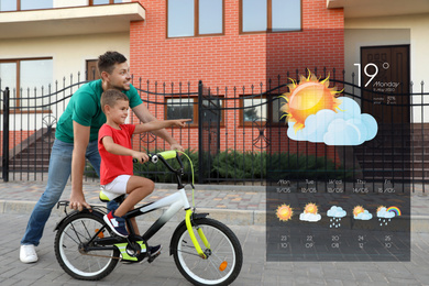 Image of Happy father teaching his son to ride bicycle and weather forecast widget. Mobile application