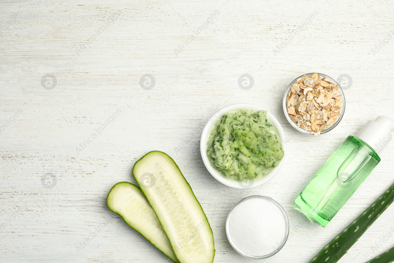 Photo of Handmade face mask and different ingredients on white wooden table, flat lay. Space for text