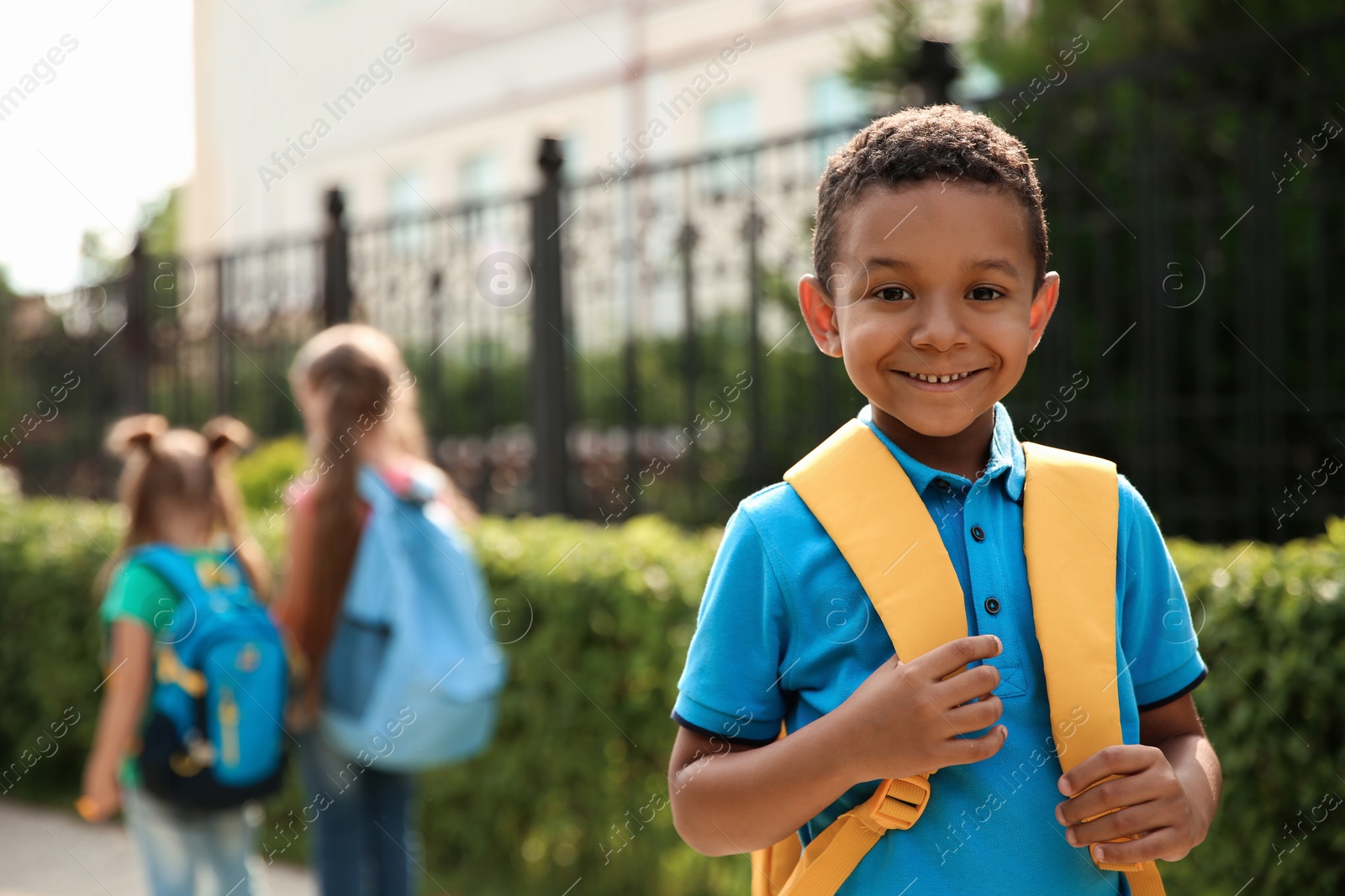 Photo of Cute little child with backpack outdoors. Elementary school