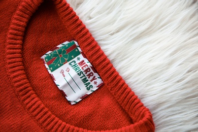 Christmas sweater with tag on fur, closeup