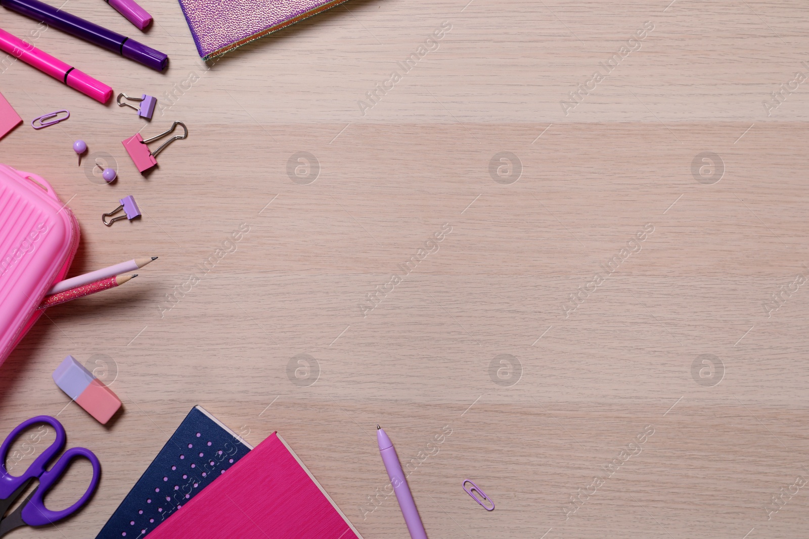 Photo of Different school stationery on wooden table, flat lay. Space for text