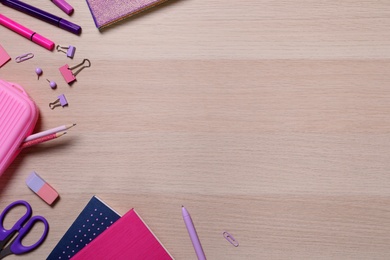 Photo of Different school stationery on wooden table, flat lay. Space for text