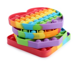 Photo of Stack of rainbow pop it fidget toys on white background