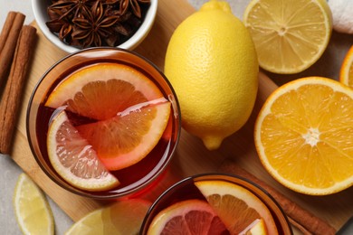Photo of Aromatic punch drink and ingredients on table, flat lay