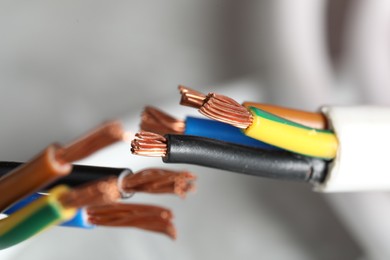 Photo of Colorful electrical wires on blurred background, closeup