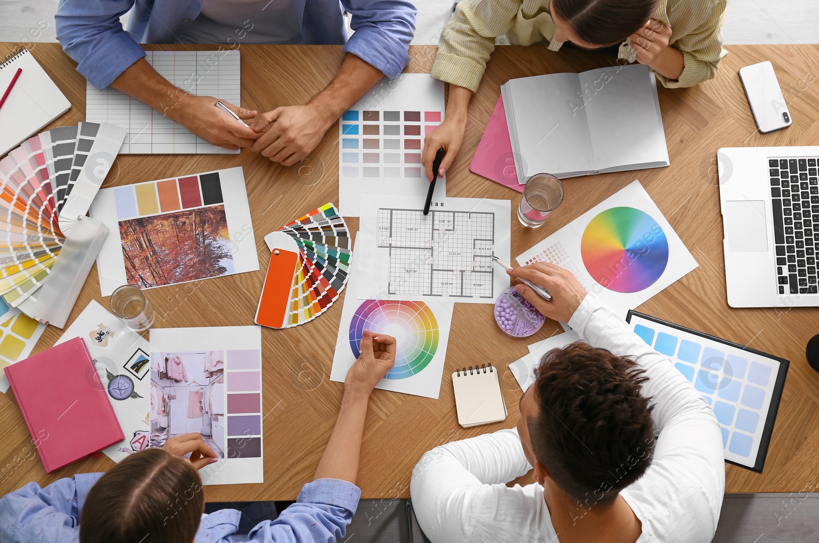 Photo of Professional team of interior designers working at table, top view