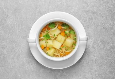 Photo of Dish of fresh homemade vegetable soup on light grey background, top view