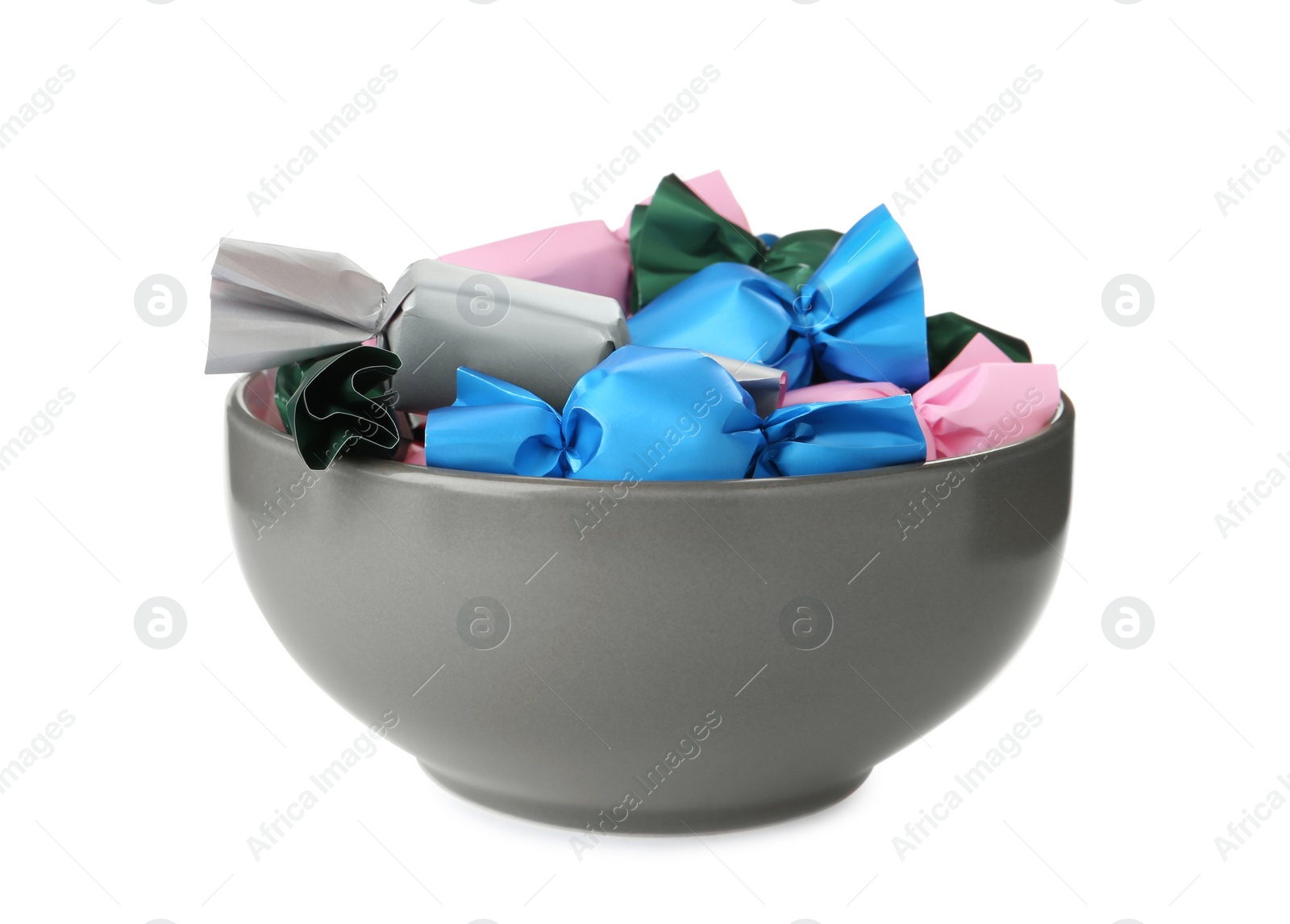 Photo of Bowl with candies in colorful wrappers isolated on white