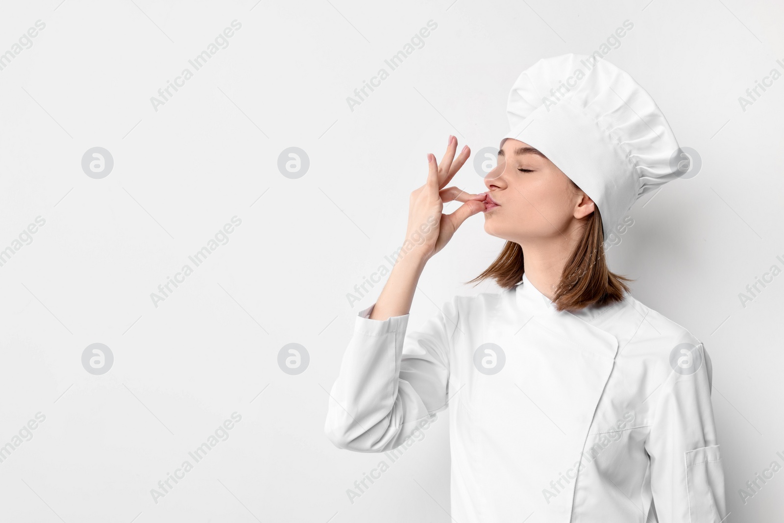 Photo of Professional chef showing perfect sign on light background. Space for text