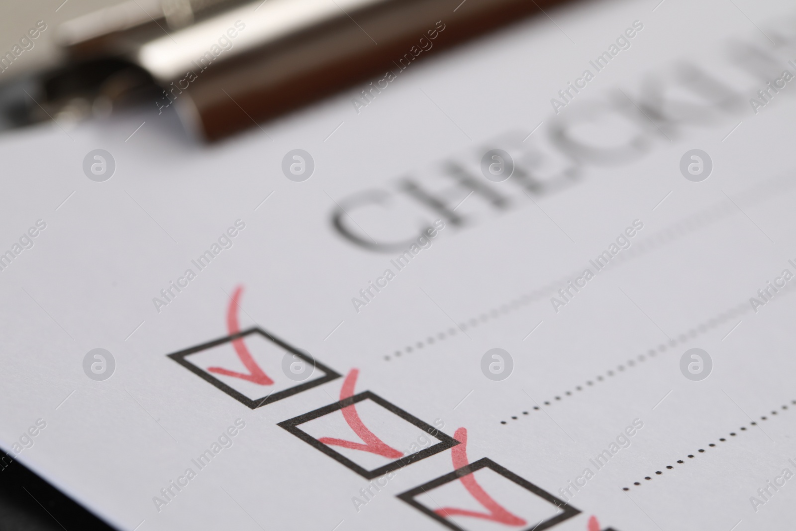 Photo of Closeup view of clipboard with inscription Checklist