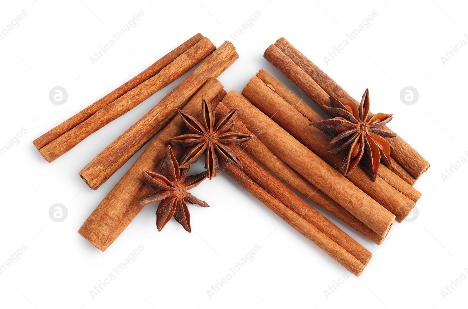 Photo of Aromatic cinnamon sticks and anise stars isolated on white, top view