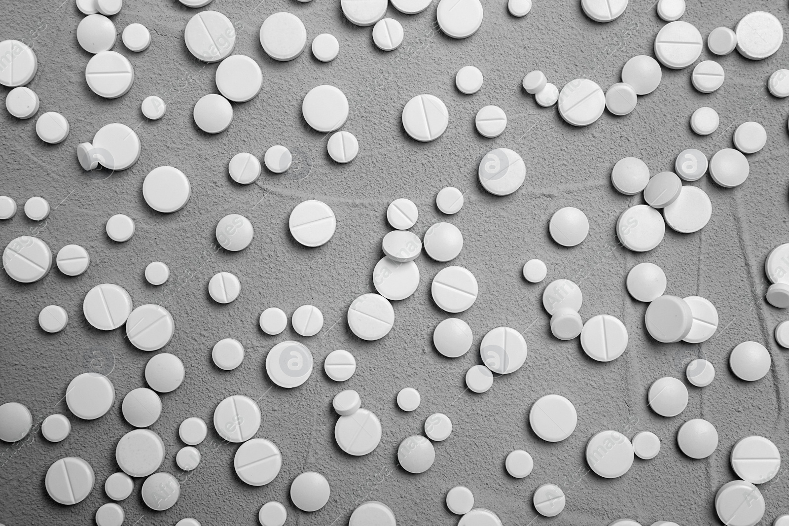 Photo of White pills on grey background, flat lay